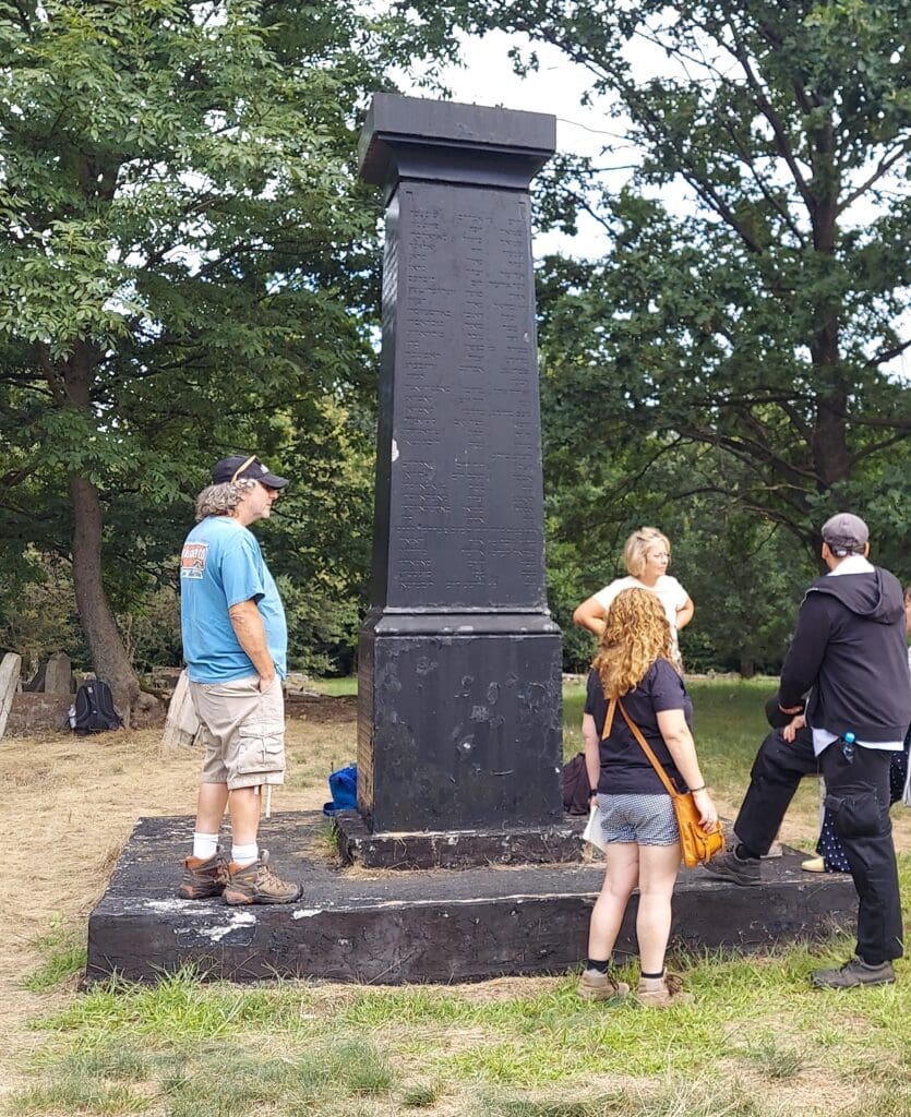 A man in black shirt standing next to woman.